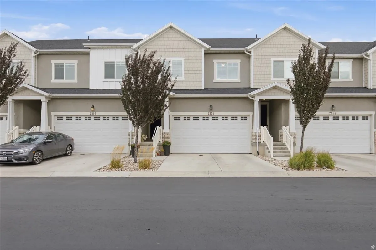 Stucco and shingle exterior with white trim