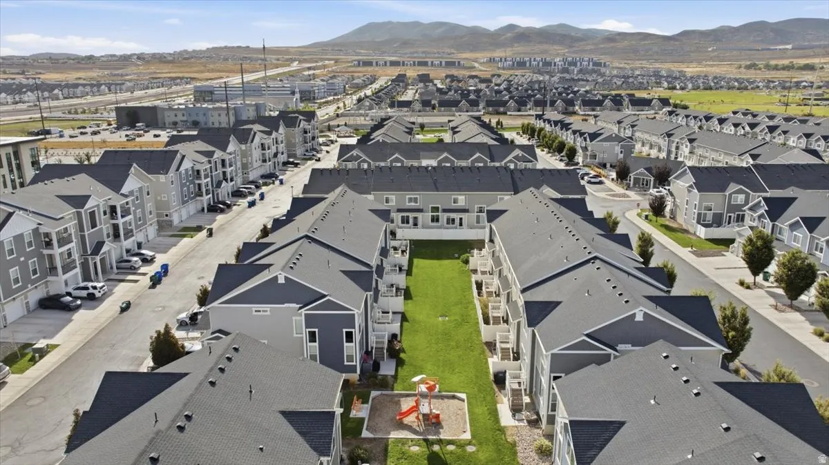 Multi-story residential buildings with dark gray shingle roofs