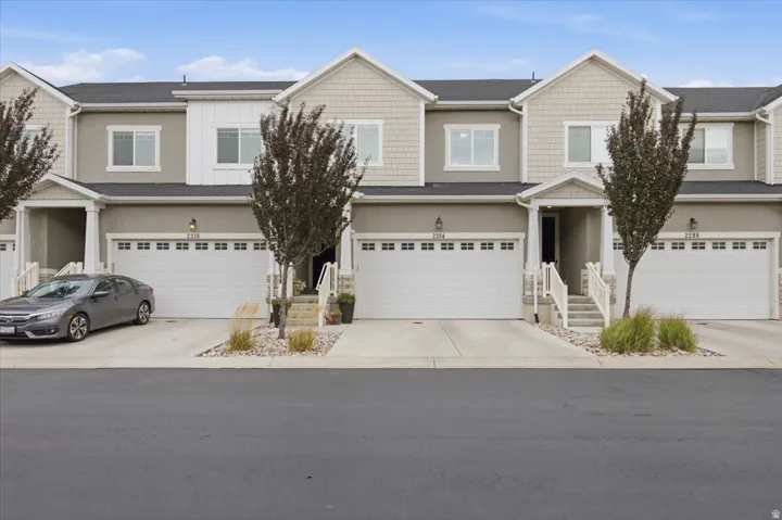 Stucco and shingle exterior with white trim