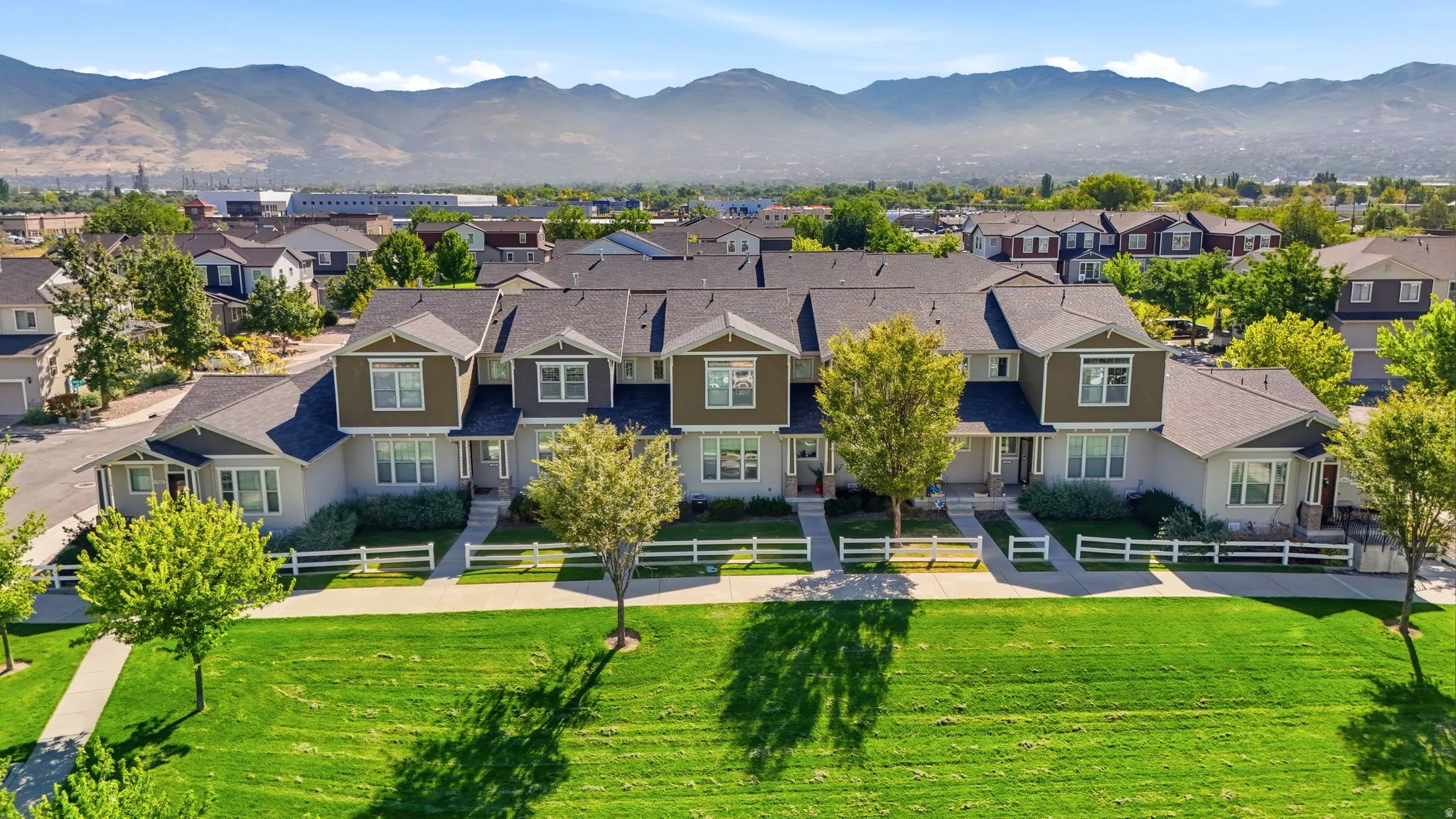 Townhome residences featuring gabled roofs, light-toned siding, and dark trim accents