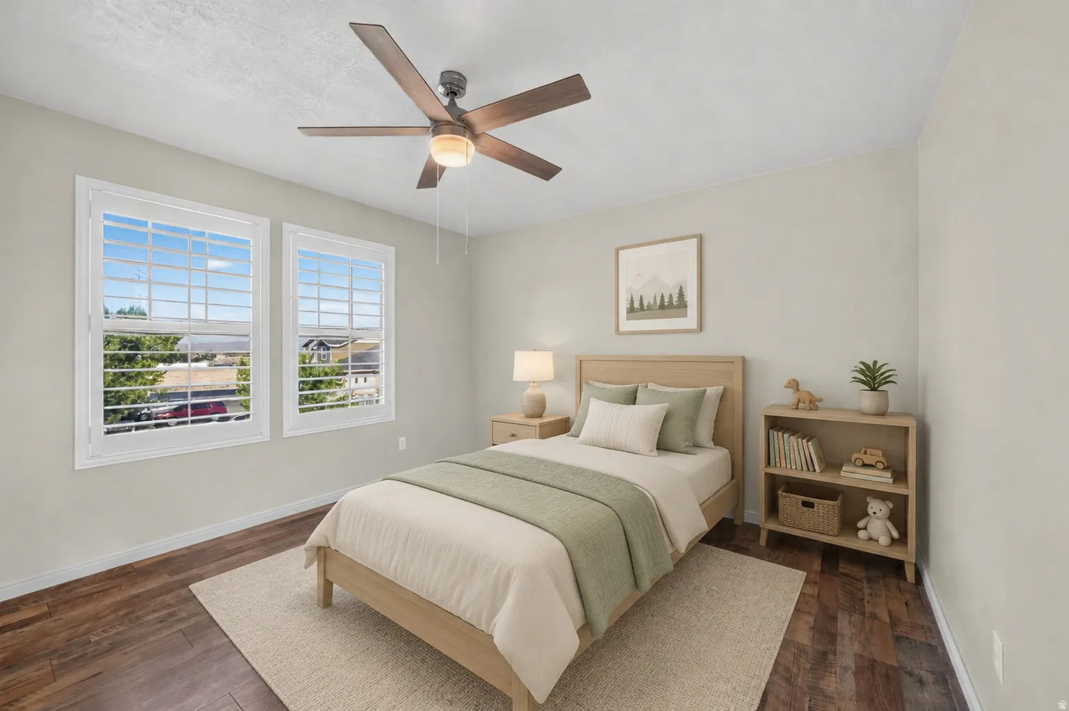 Dual windows with white framing, wood-finish flooring, and a ceiling fan with integrated lighting