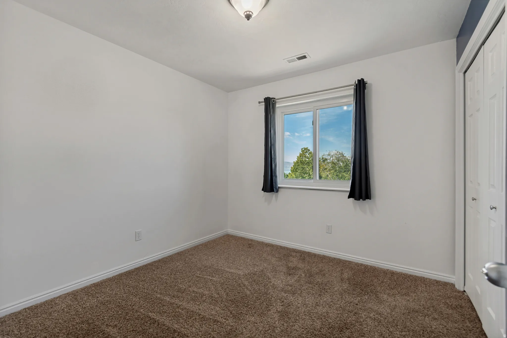 Upstairs unstaged bedroom