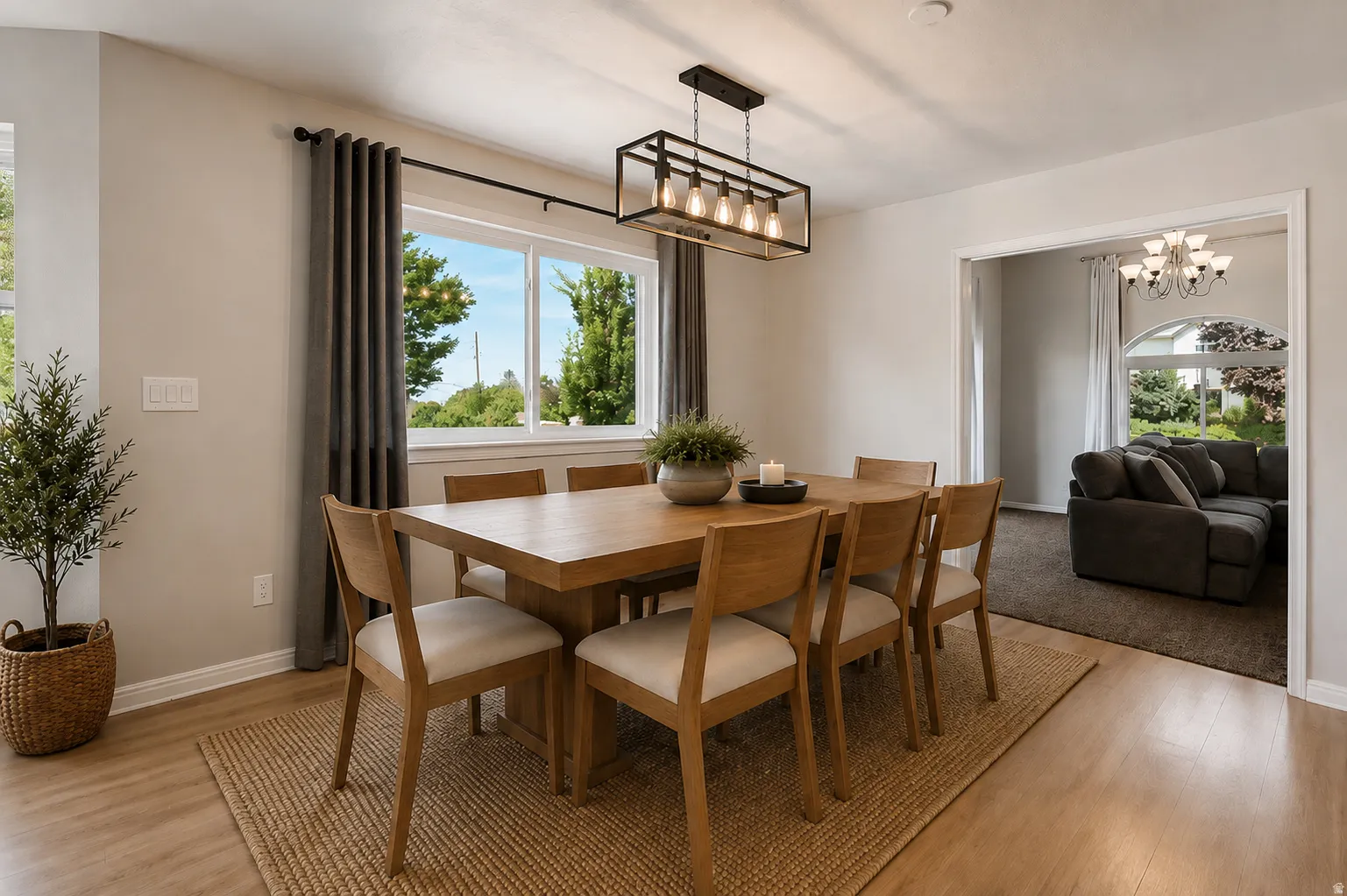 Open kitchen and dining area, French doors to large valley-view deck, kitchen island, abundant cabinets and counter space, large windows, custom decorative wall, and plenty of natural light