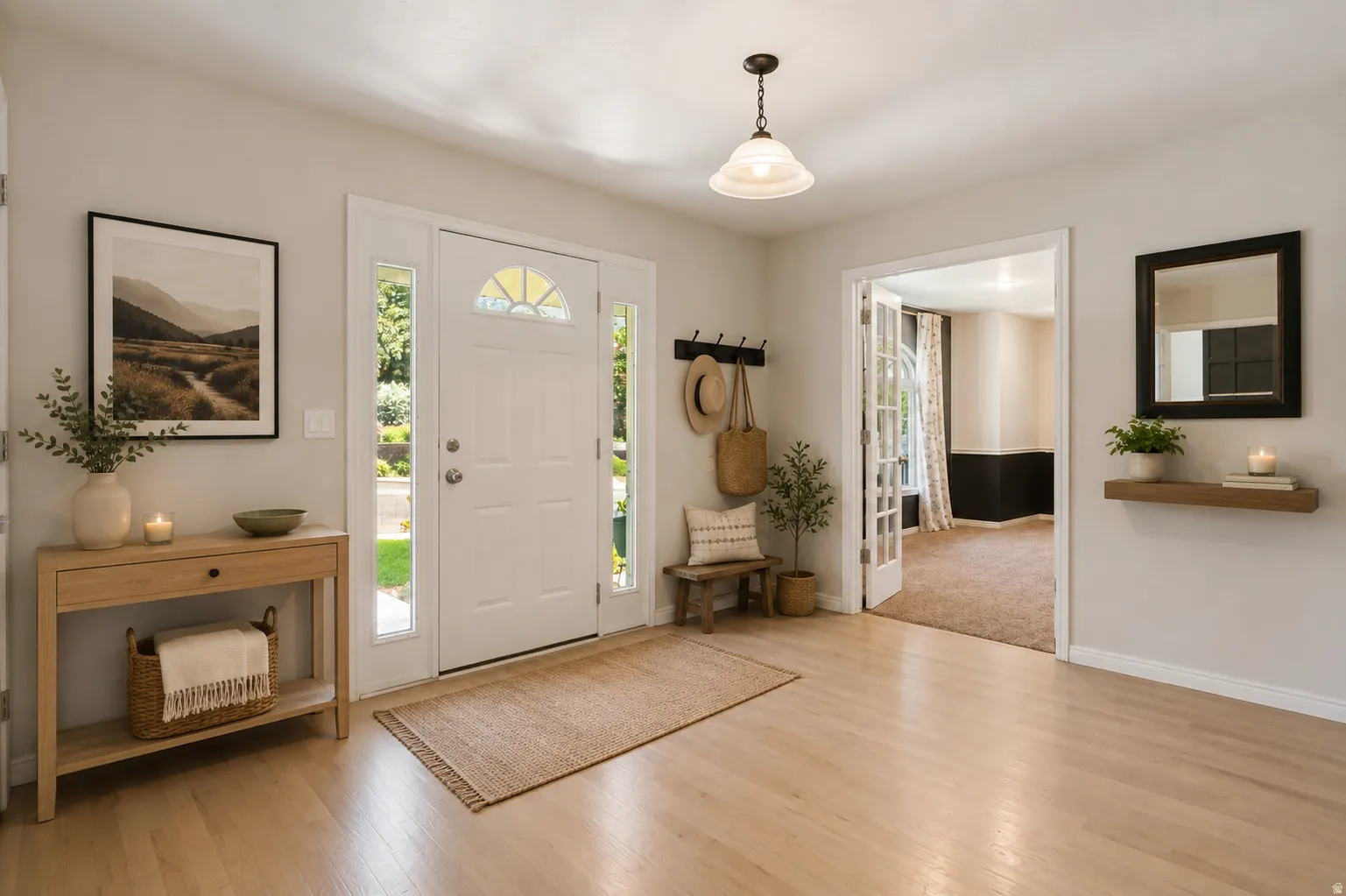 Large entryway featuring light hardwood flooring  and french doors to study
