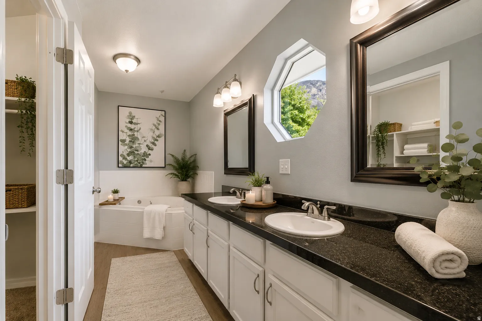 Large, spa-like primary en suite bathroom with dual vanity, huge built-in soaking tub