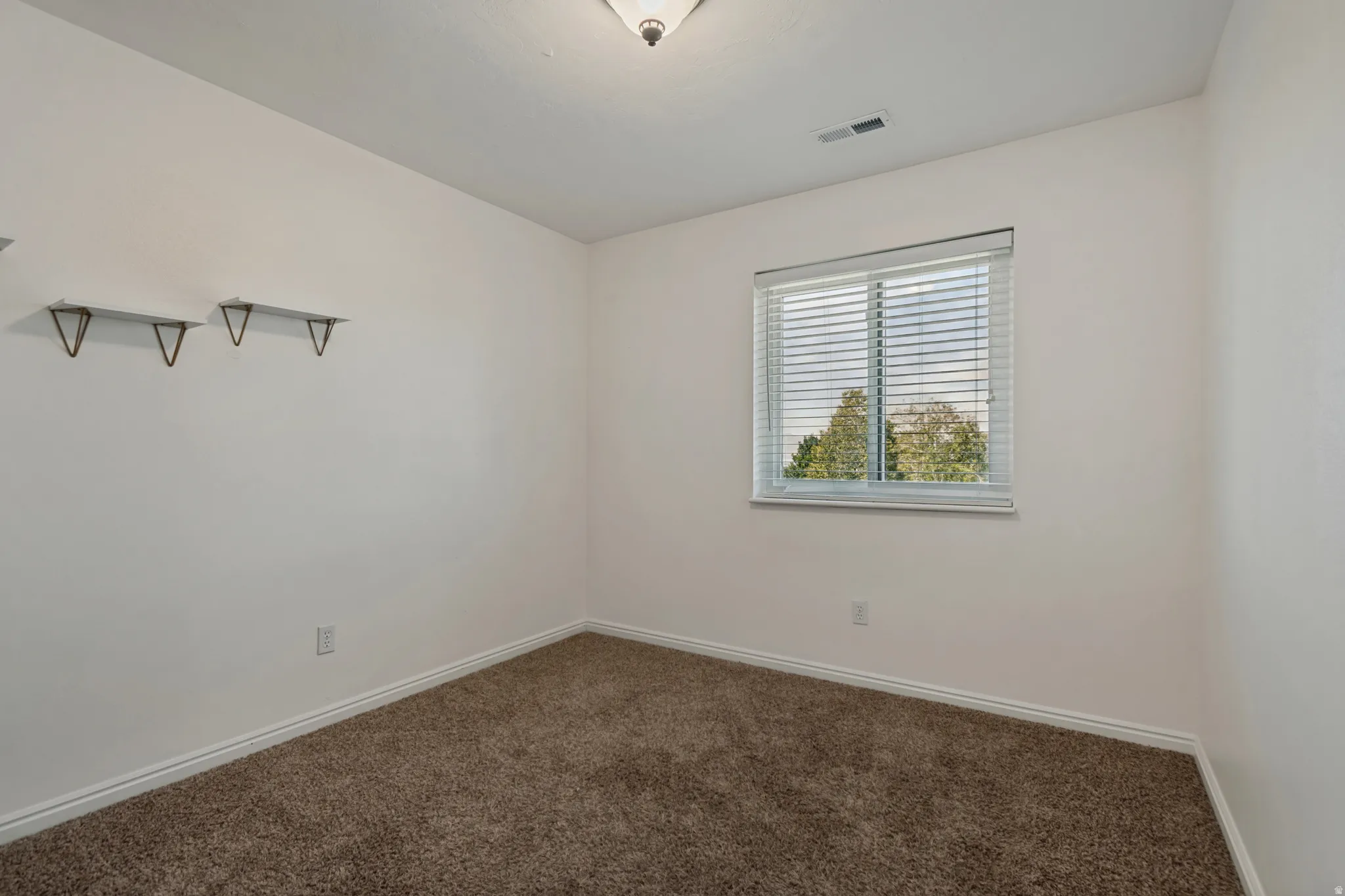 Unstaged upstairs bedroom