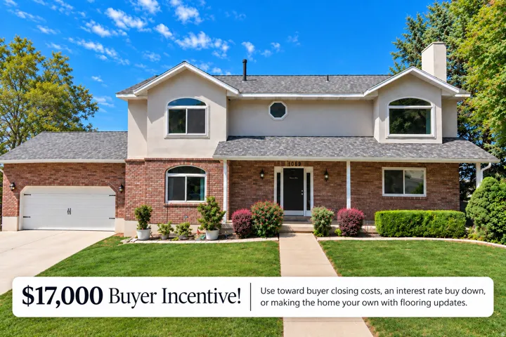 Stucco and brick exterior with a front entry, multiple arched windows, and an attached two-car garage extra RV parking to left of garage