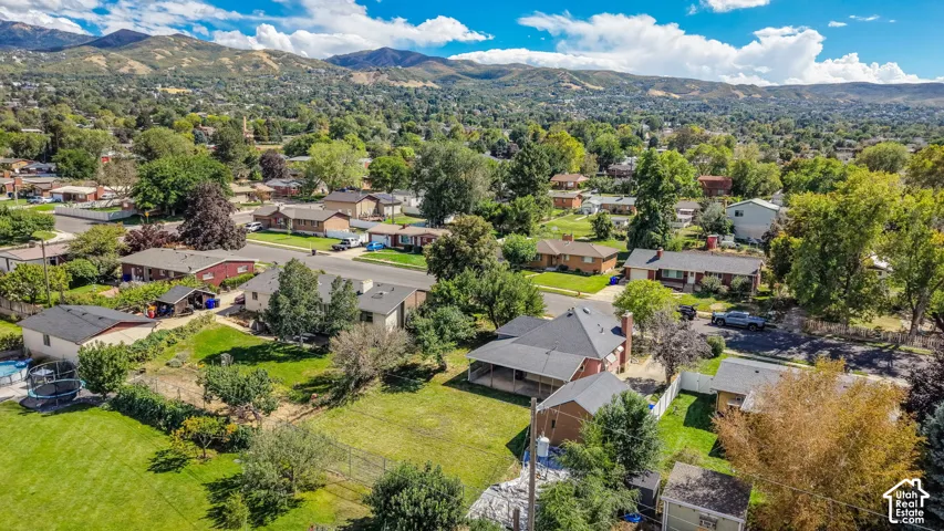 Expansive property with mature trees, established landscaping, and mountain scenery