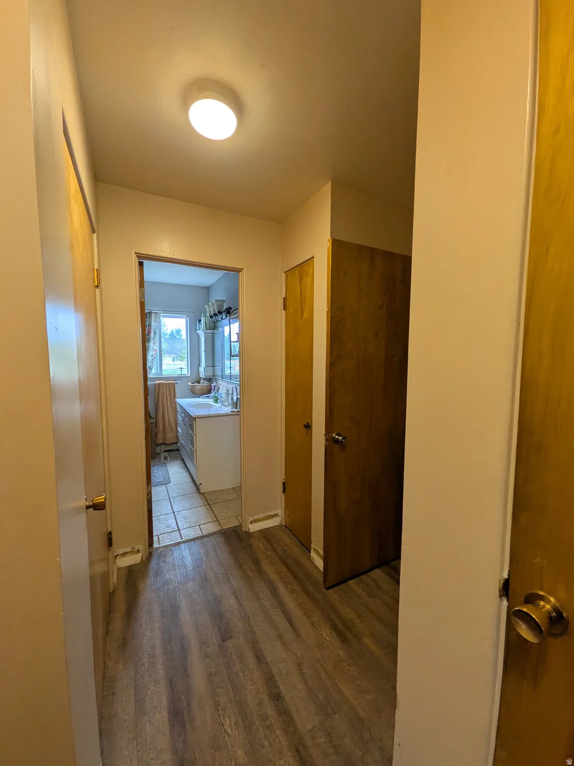 Wood-finish flooring throughout the hallway