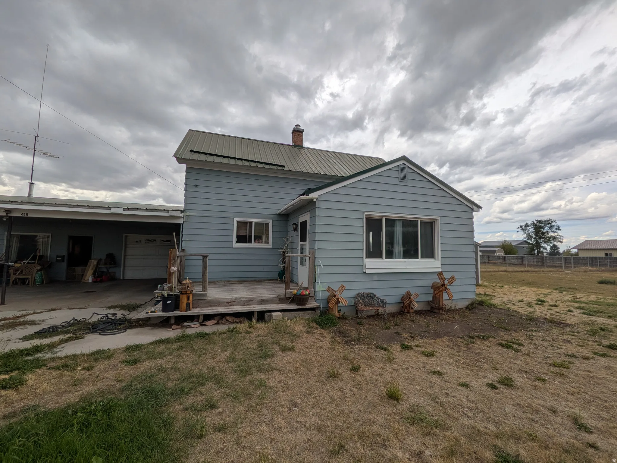 Light blue siding exterior with a metal roof