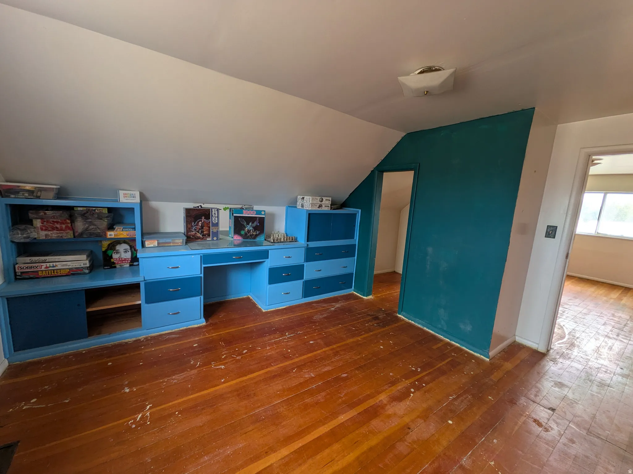 Wood-finish flooring with built-in cabinetry and desk