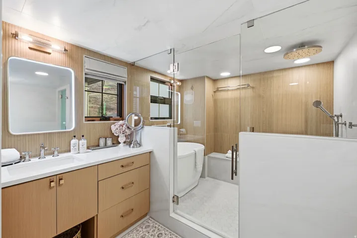 Wood-finish vanity with dual sinks and chrome fixtures