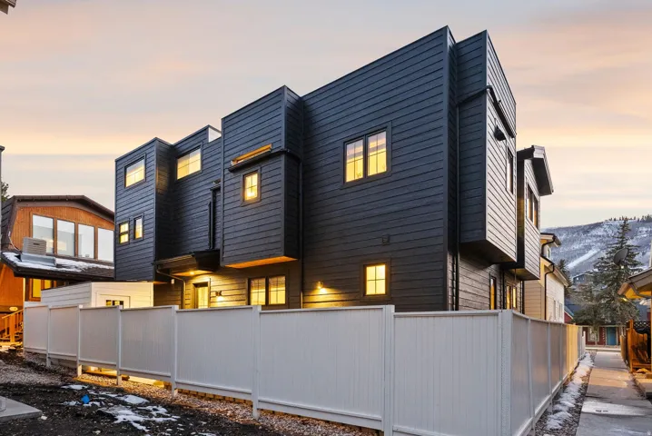 Modern multi-story exterior with dark horizontal siding