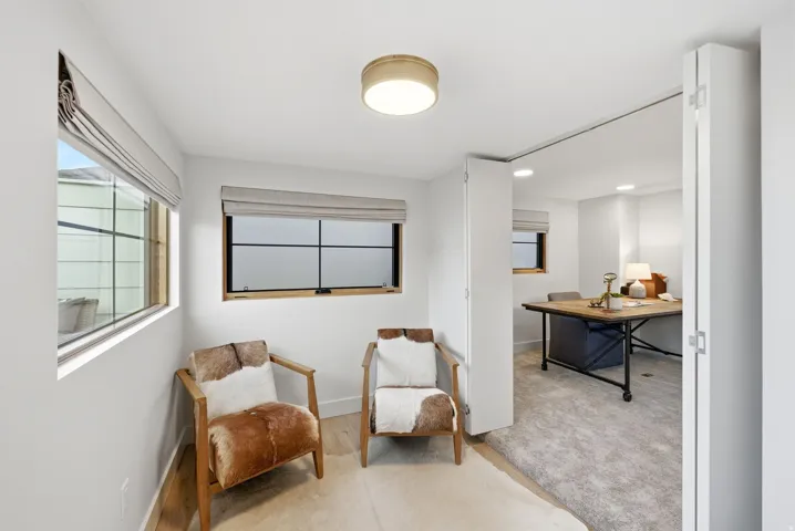 Natural light from multiple windows, light wood-finish flooring, recessed lighting, and a modern ceiling fixture
