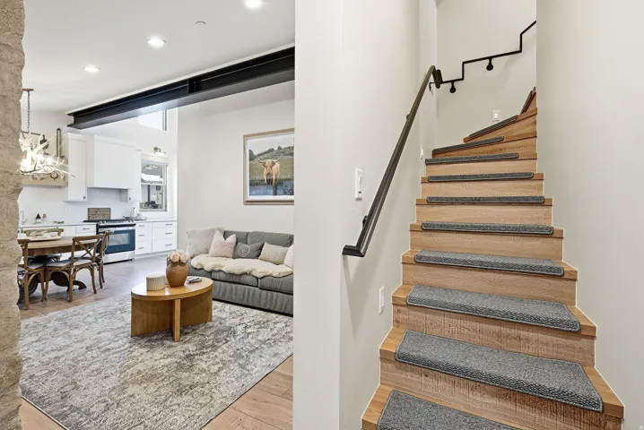 Wood-finish staircase with modern black handrails