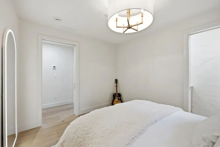 Recessed lighting, wood-finish flooring, and a contemporary ceiling fixture