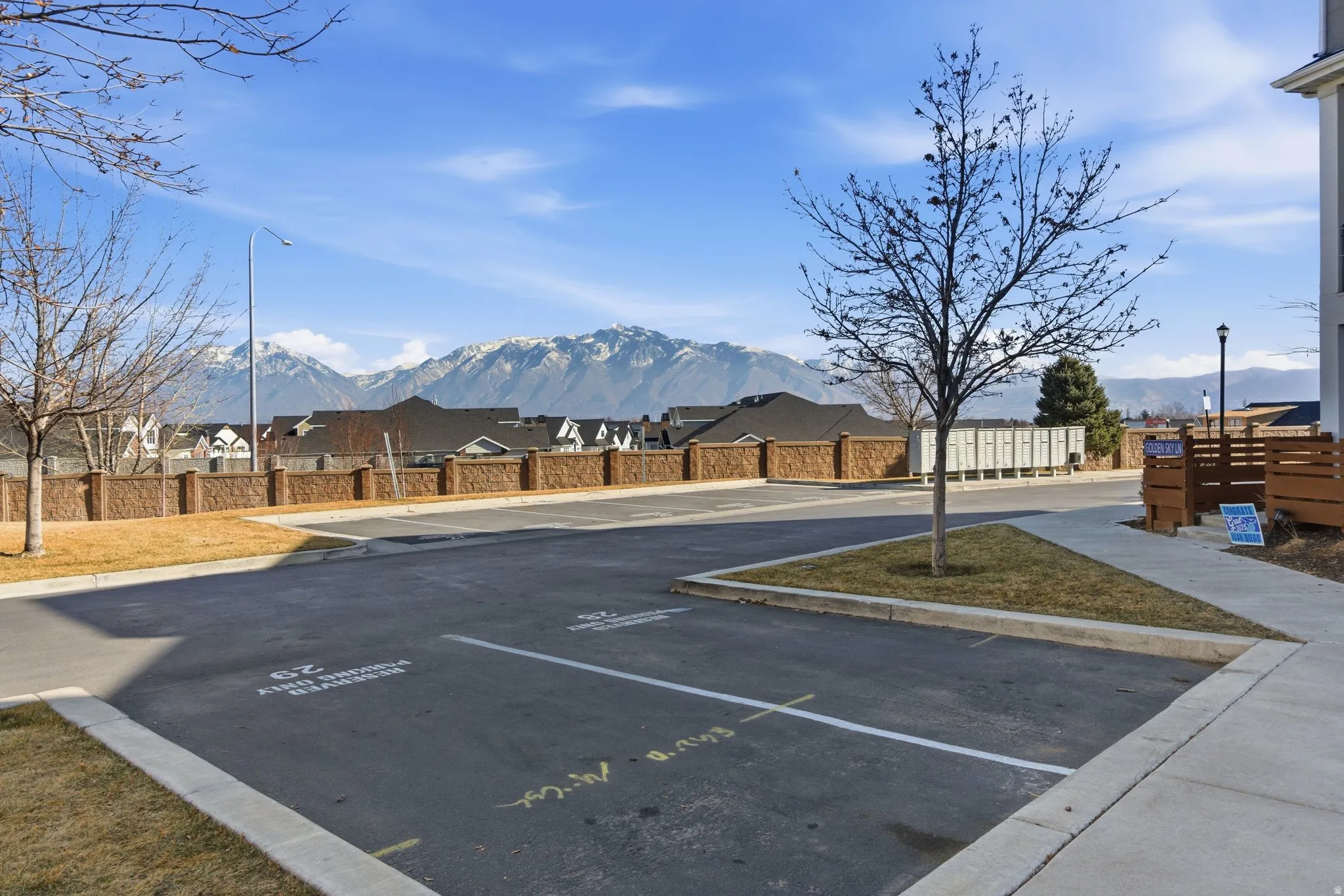 Paved parking area with marked spaces and concrete curbing
