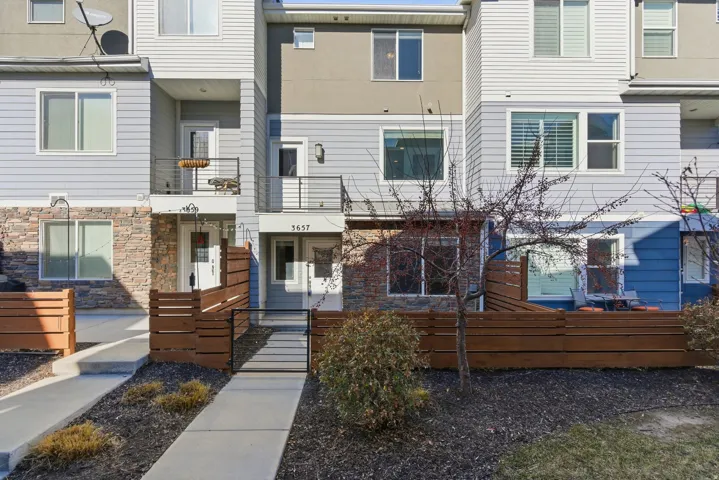 Multi-level townhome with stone and siding exterior