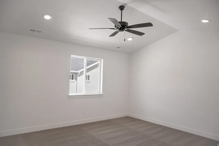 Primary bedroom with vaulted ceilings