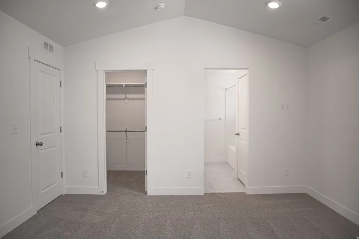 Primary bedroom with full bath and walk-in closet