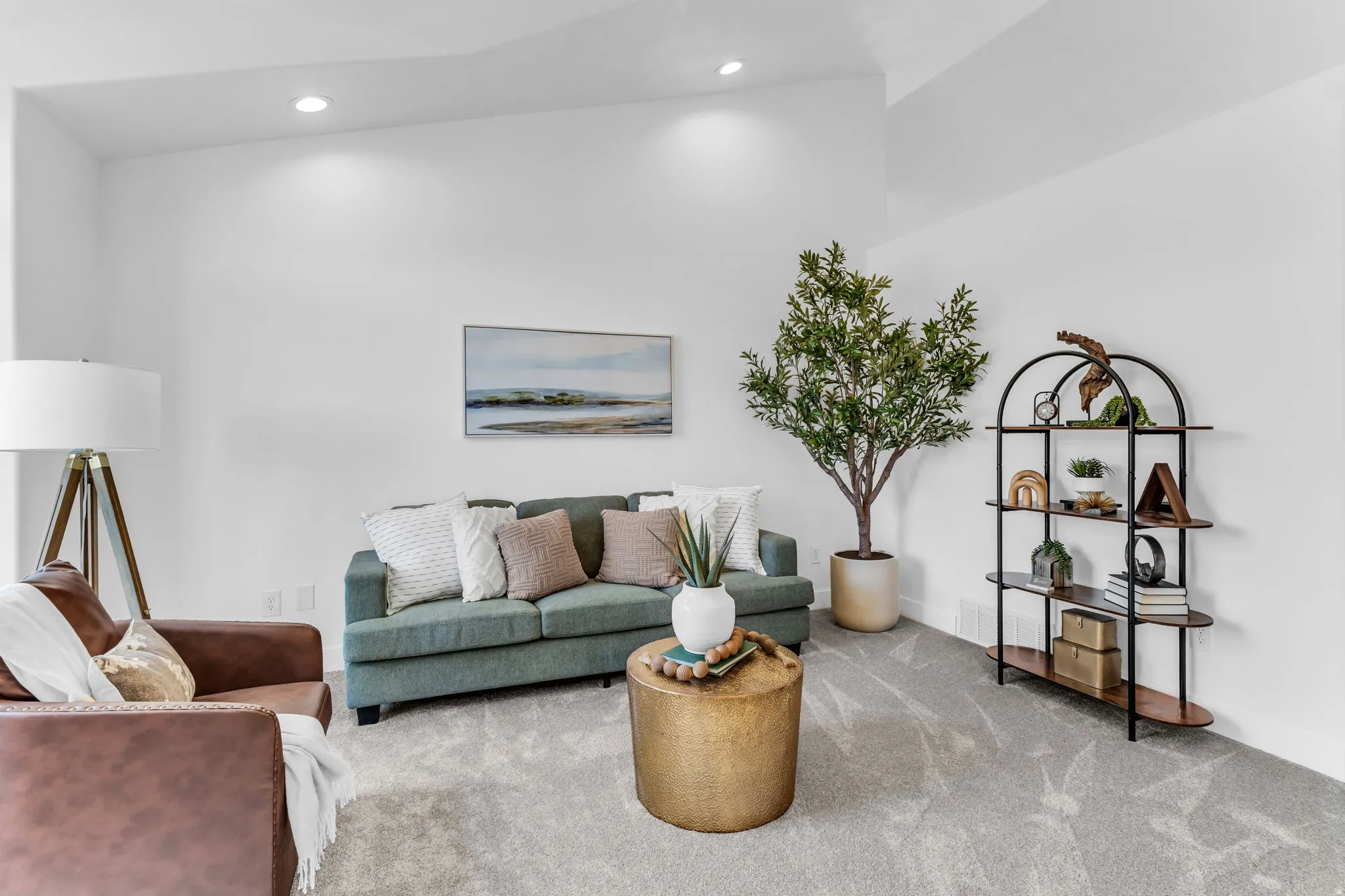 Recessed lighting illuminates the neutral wall colors and light grey carpeting