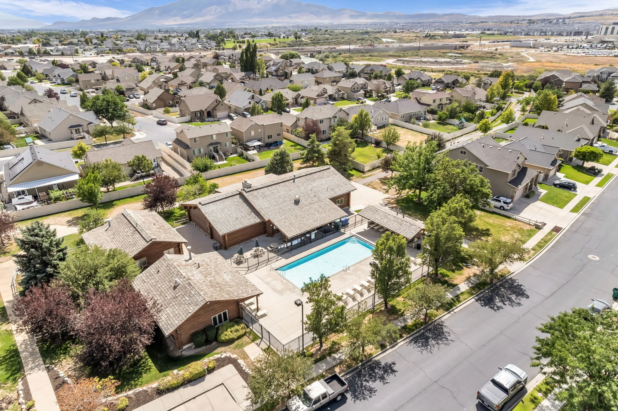 Swimming pool with surrounding concrete patio and fenced perimeter