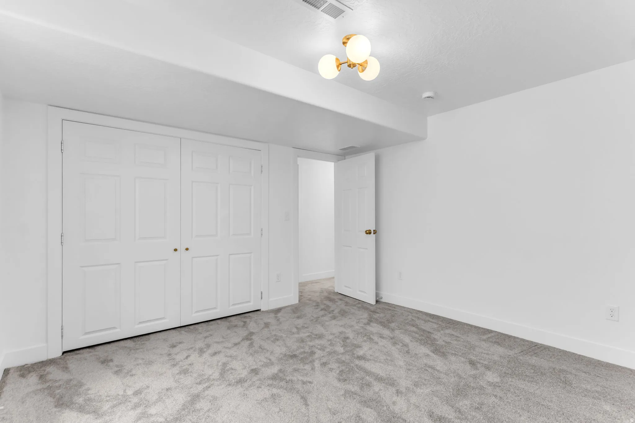 Plush gray carpeting and white walls