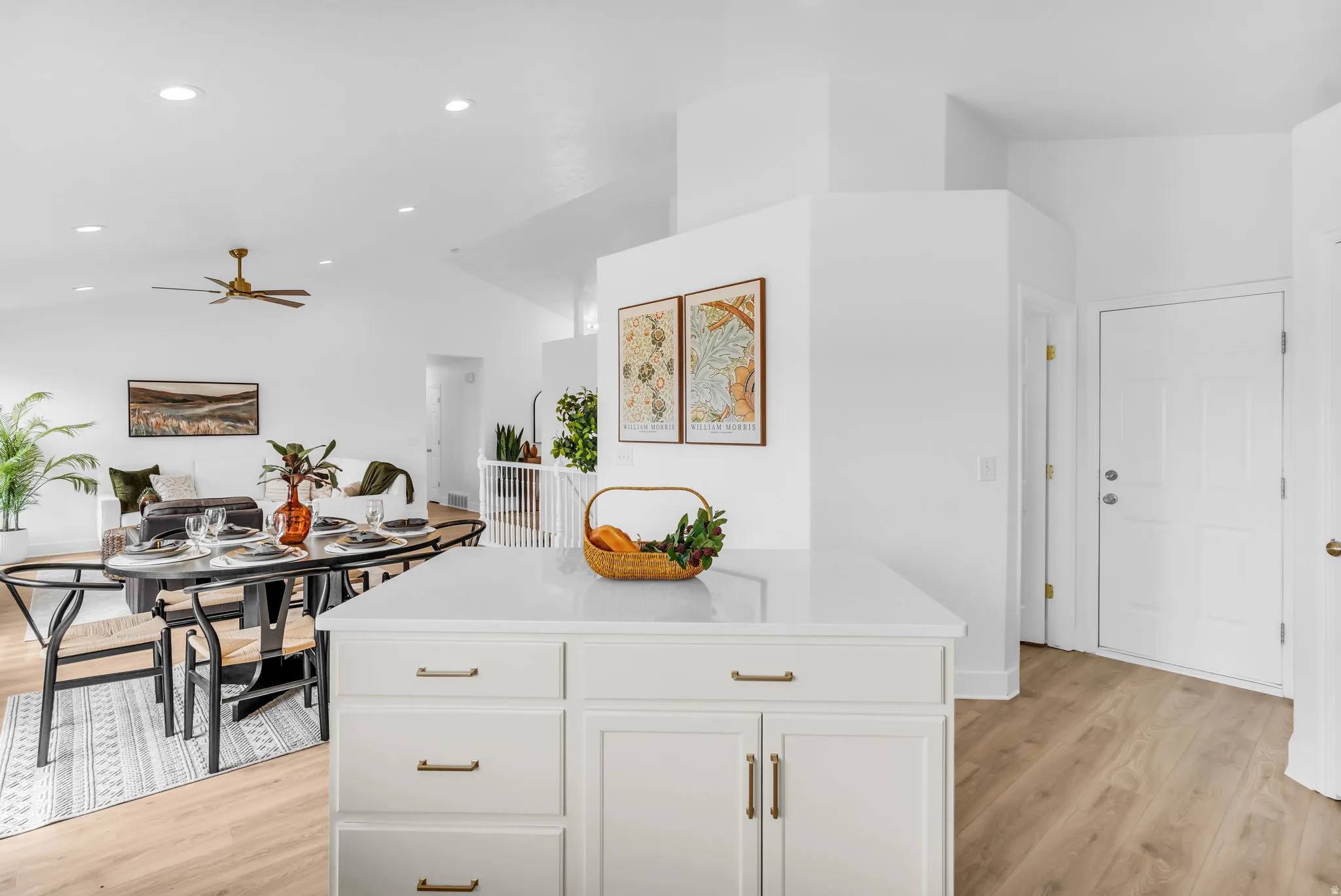 Kitchen island with white cabinetry and a light-toned countertop
