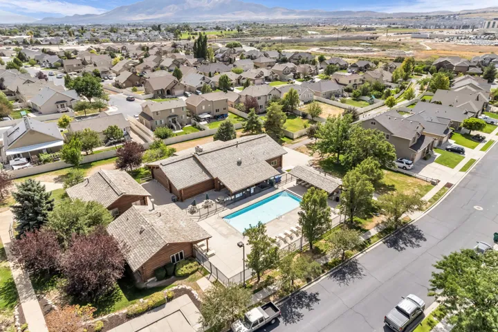 Swimming pool with surrounding concrete patio and fenced perimeter