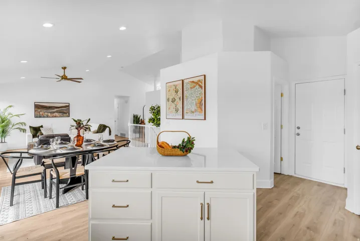 Kitchen island with white cabinetry and a light-toned countertop
