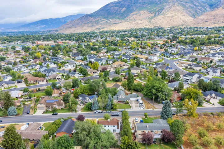 Residential area featuring mature trees and a mountainous backdrop
