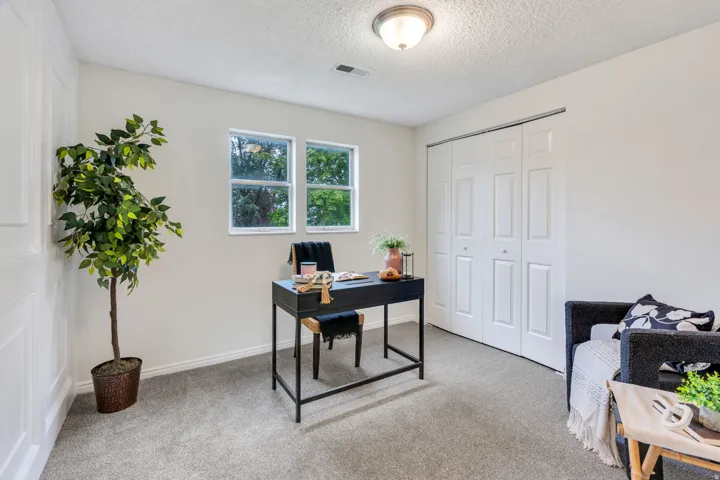 Neutral wall color with two pane windows and textured ceiling