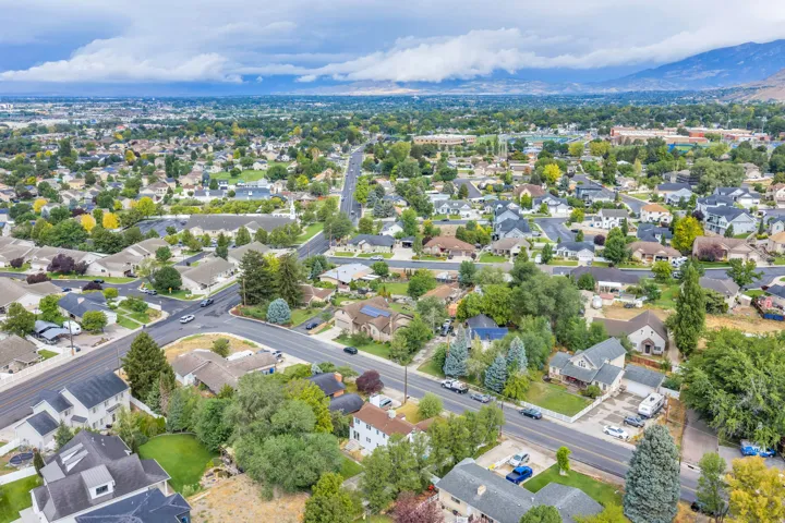 Expansive residential area with mature trees and mountain backdrops