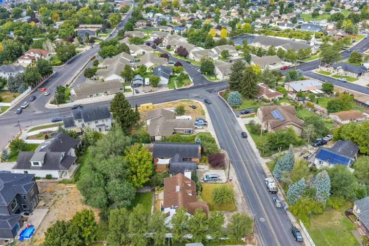 Aerial perspective of a residential neighborhood with mature trees and established streets
