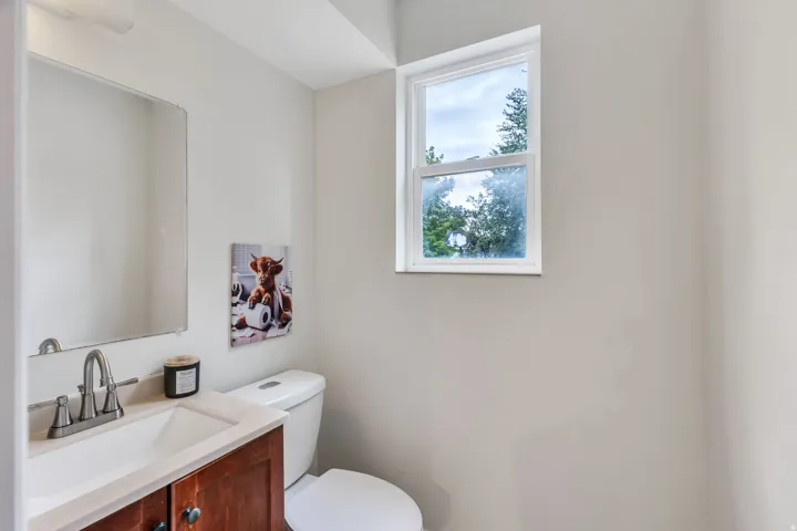 Recessed lighting with a rectangular mirror, a single-handle faucet, and an undermount sink