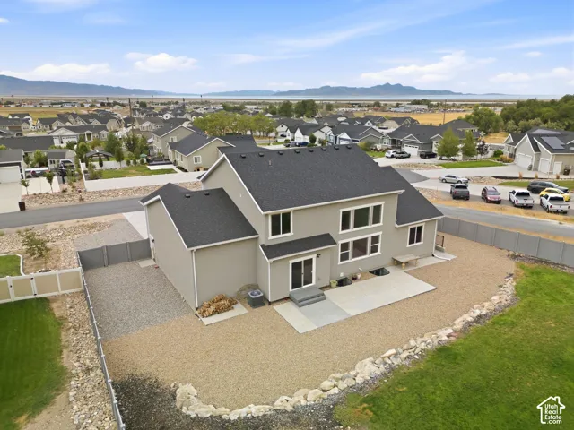 Contemporary exterior with multiple windows, a rear patio, and a gravel landscape