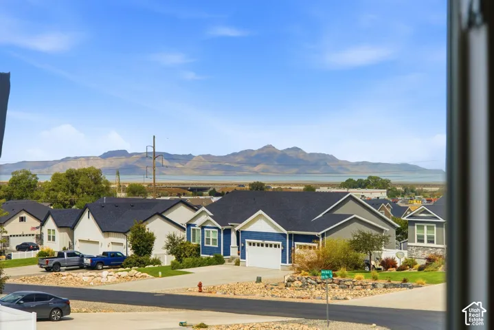 Neighborhood setting with distant mountains and a body of water