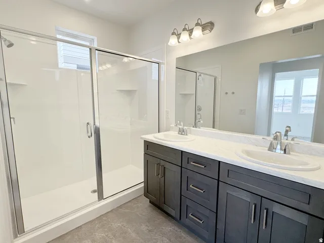 Double vanity with undermount sinks and dark cabinetry