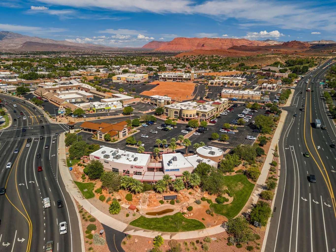 Expansive commercial development featuring multiple buildings, surface parking, and mature landscaping