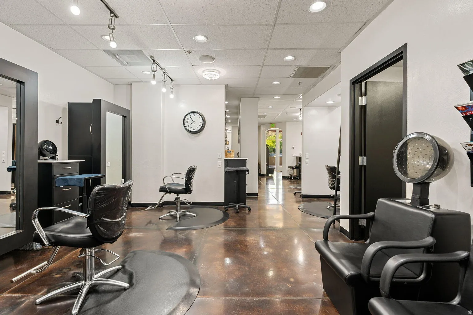 Polished concrete flooring, recessed lighting, and track lighting fixtures