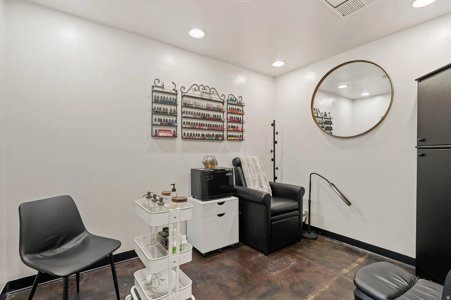 Recessed lighting illuminates the space, featuring a dark-toned floor and white walls