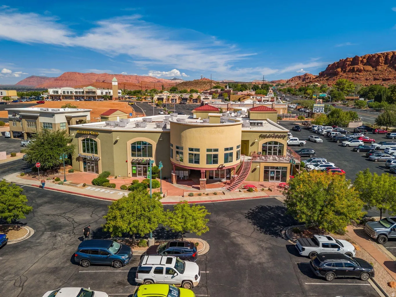 Retail center featuring multiple storefronts, ample surface parking, and distinct architectural styles