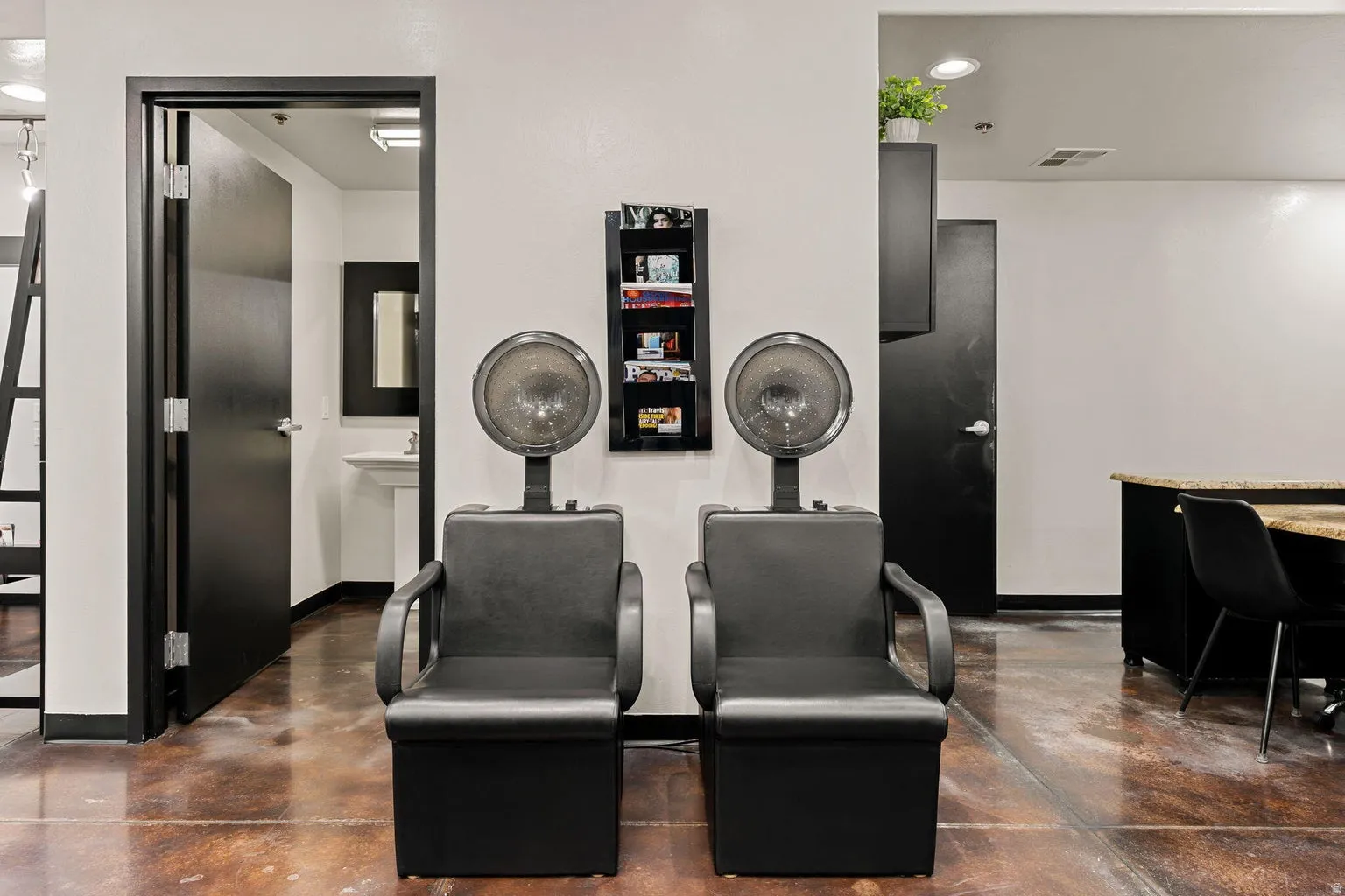 White walls, dark trim, and dark doors