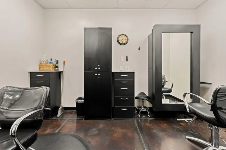 Hard-surface flooring, built-in cabinetry, and wall-mounted mirror with integrated shelving