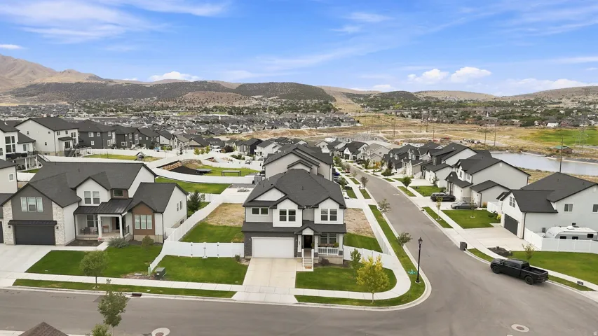 Modern two-story residence with a two-car garage, covered porch, and landscaped front yard, situated on a corner lot