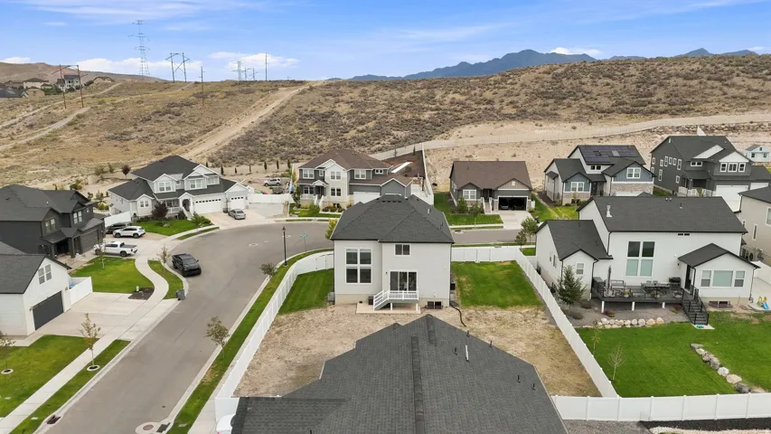 Newly constructed residence with a fenced backyard, featuring a patio, and a modern exterior with large windows