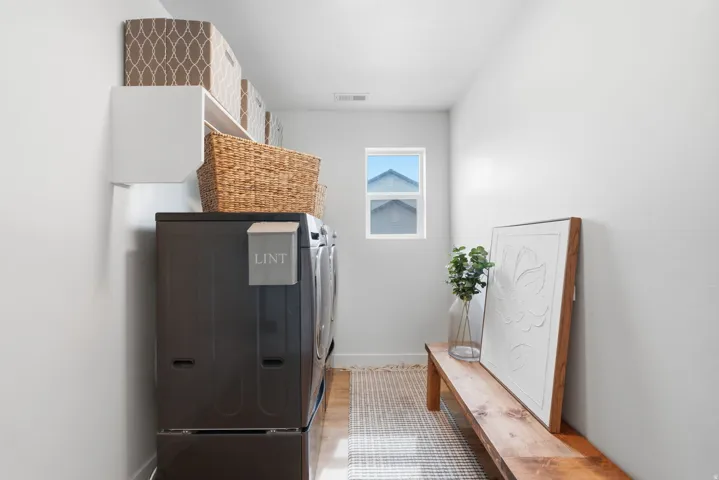 Built-in wall shelving, light wood-finish flooring, a window, and white walls
