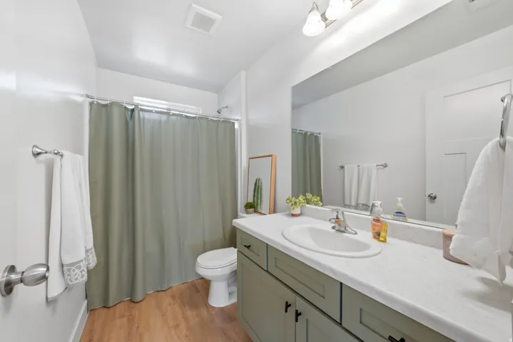 Vanity with light-toned countertop, integrated sink, and recessed cabinetry