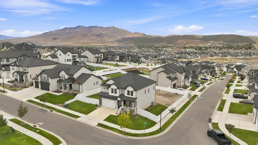 Newly constructed residential property featuring a two-story design, attached garage, and a covered front porch