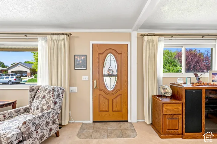 Front entry with a wood-finish door featuring an oval leaded glass insert, flanked by two windows